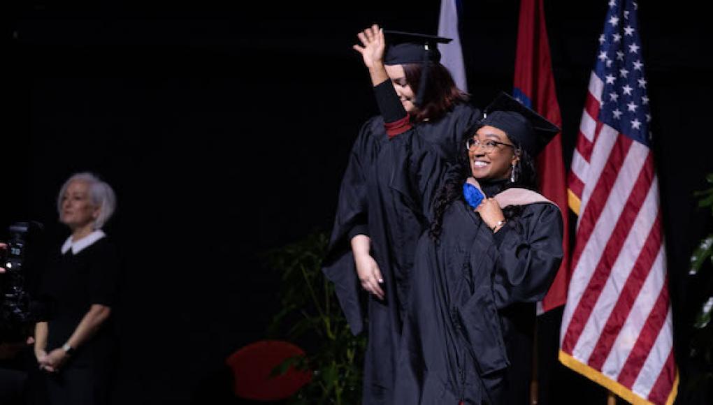 Student receiving her degree at commencement