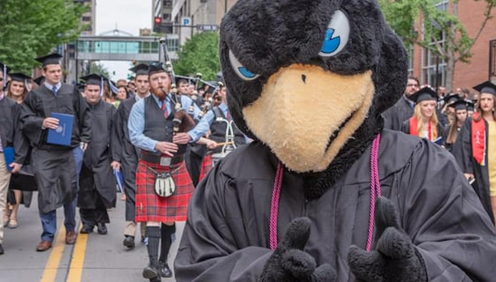Rock E. Hawk leading a graduation parade