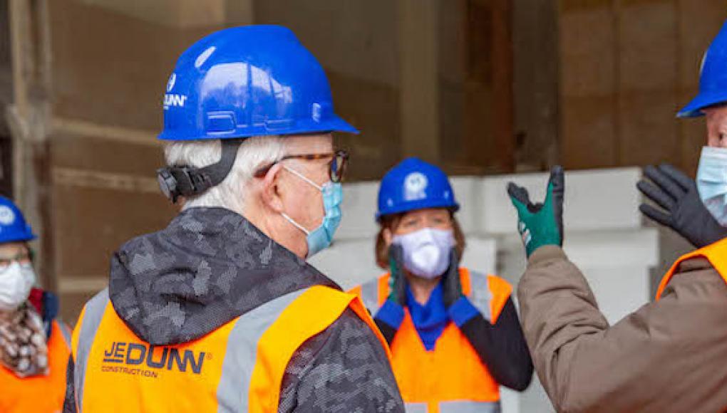 Alumni and staff on a tour of a construction site