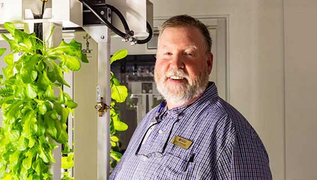 Bruce Turnbough in the cafeteria's hydroponic grow room