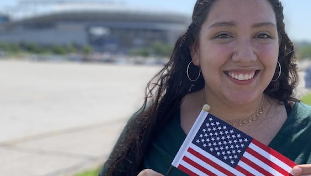 Student Karen Bravo holding an American flag