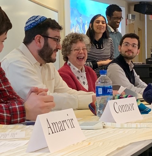 Interfaith Panel - three individuals at a table with two looking on