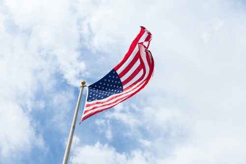 An American flag flying, as viewed from below