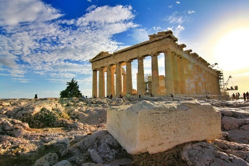 Parthenon in Greece set against blue sky with clouds