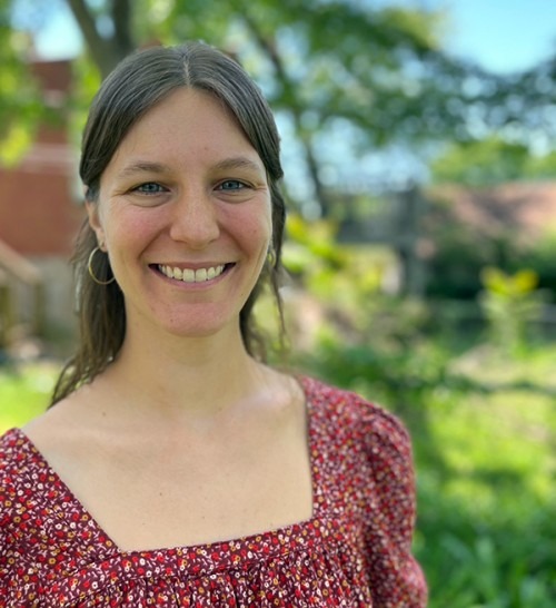Claire Bukemper headshot with farm in the background