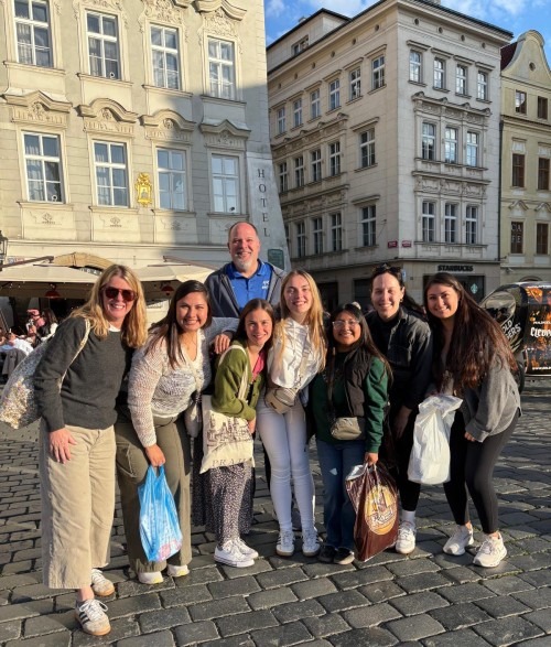 Students and professor on a study abroad trip to Prague Czechia pose on the street 