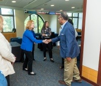 Two people shaking hands in Conway's lobby