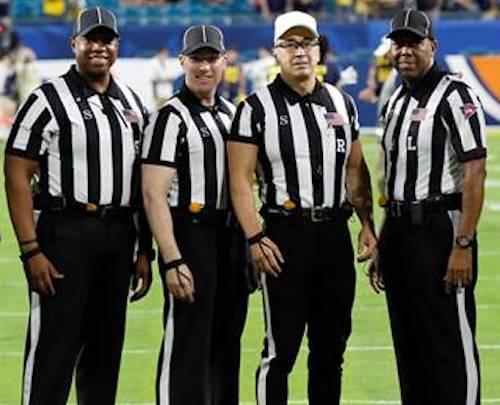 Alumnus Chris Tallent and other referees on the field