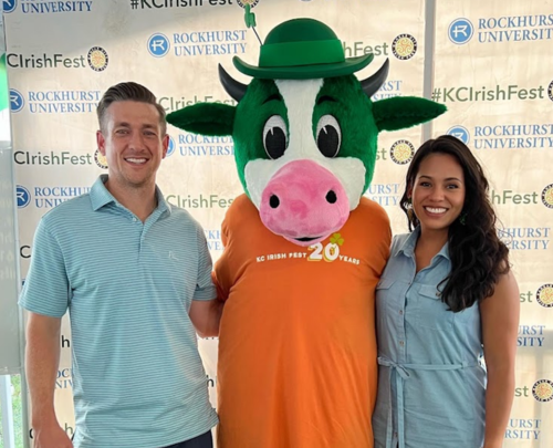 Guests at our Rockhurst Irish Fest Tent along with the Irish Fest cow mascot.