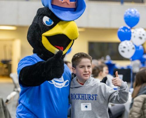 Rock E. Hawk with a kid guest at Alumni Night at the Ballgame