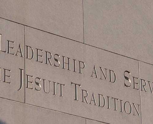 Bell tower inscription. Learning, leadership, and service in the Jesuit tradition