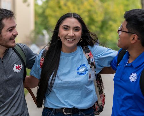 Students smiling and talking on campus