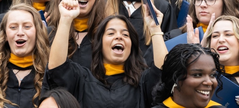 Students cheering after being hooded as part of the commencement weekend activities