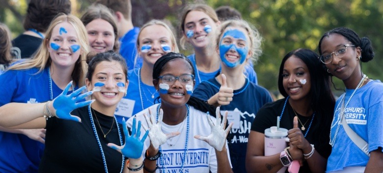 Students with facepaint smiling