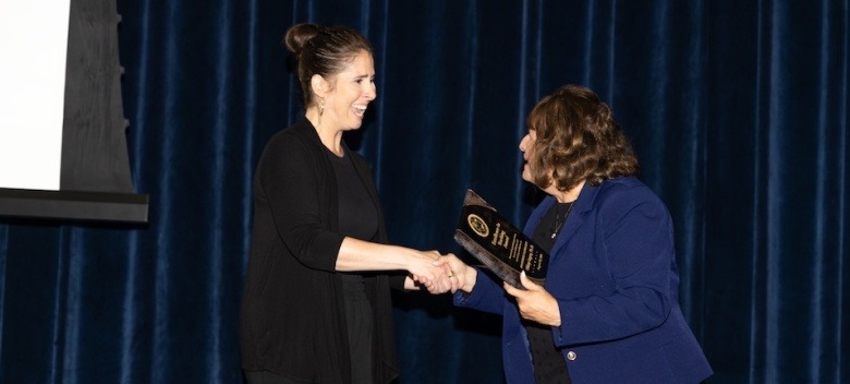 Hilary Logan accepting an award for teaching excellence.