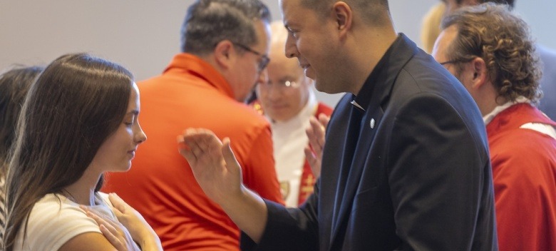 Br. Carl Carceres blesses a student.