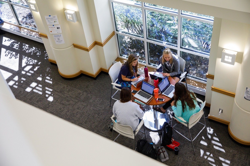group of 4 students studying in the science center