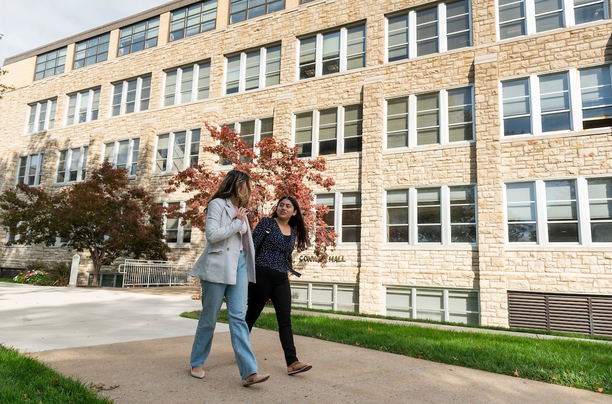 Two girls walk in front of Conway Hall