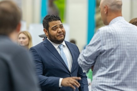 Student in suit talks with recruiter