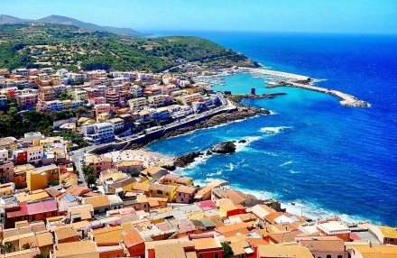 Town buildings, beach, and marina in Sardinia, Italy