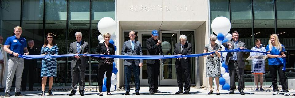Officials cutting the ribbon on Sedgwick Hall