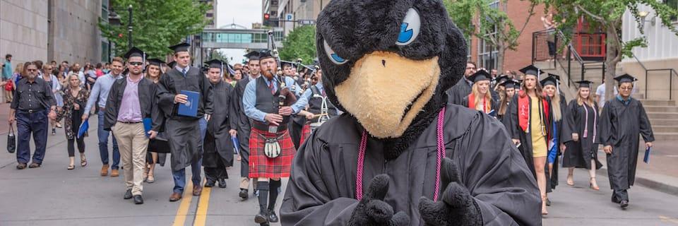 Rock E. Hawk leading a graduation parade