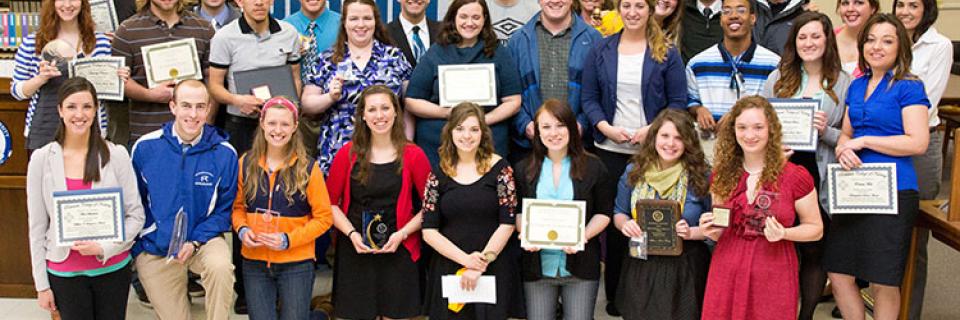 A group of students accepting awards