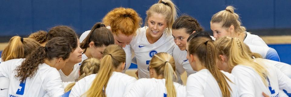 Volleyball players in a huddle