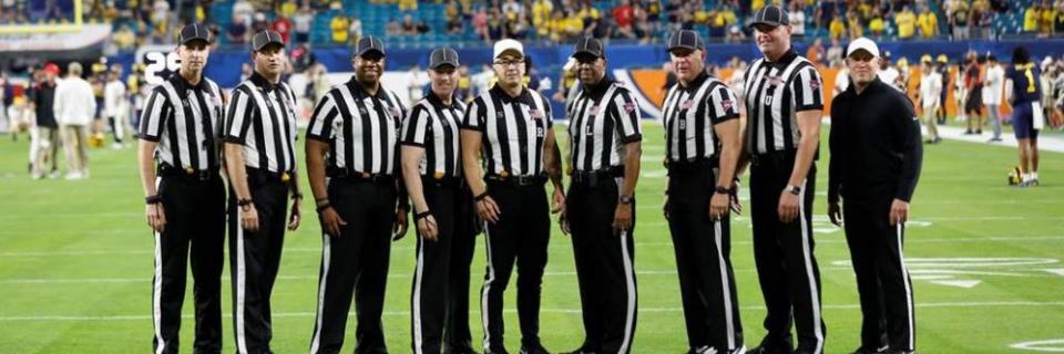 Alumnus Chris Tallent and other referees on the field