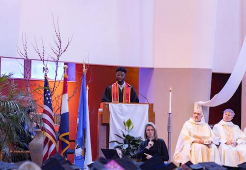 A graduate speaks at Rockhurst Commencement Mass 2023