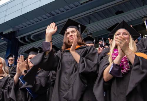 Students waving during commencement