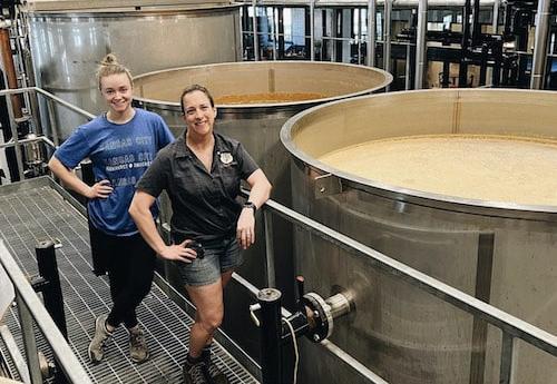 Emma Miller and a coworker at a distillery