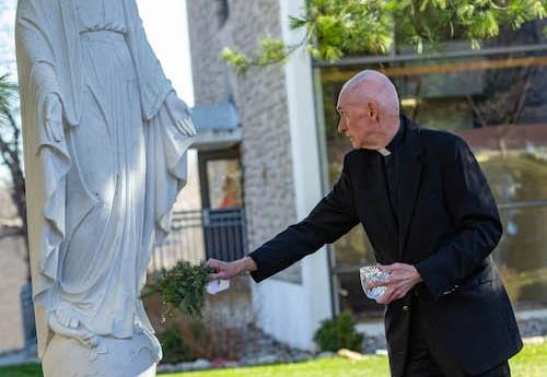 Fr. Curran blesses the statue of Mary