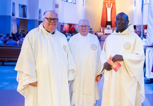 Fr. Dave Holloway, center, served first in the Navy, and then as a chaplain