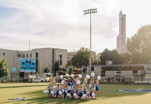 Spirit and Dance Team with Mascot on Rockhurst University Campus, center-field.