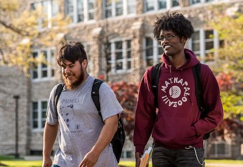 Students talking while walking across campus