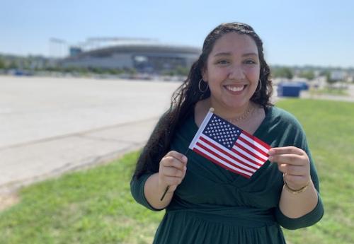 Student Karen Bravo holding an American flag
