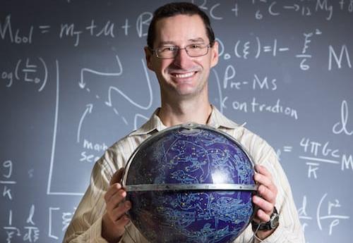 Mark Pecaut holding a globe
