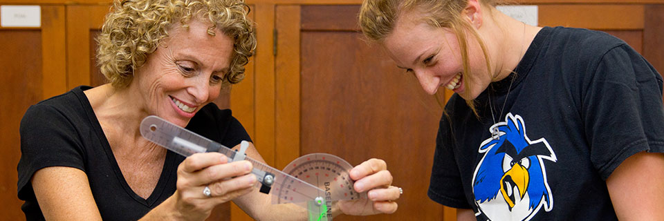 Traditional Physics Professor and student conducting experiment